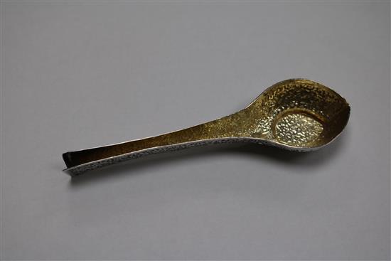 An Indian white metal pouring vessel and a continental apostle spoon.